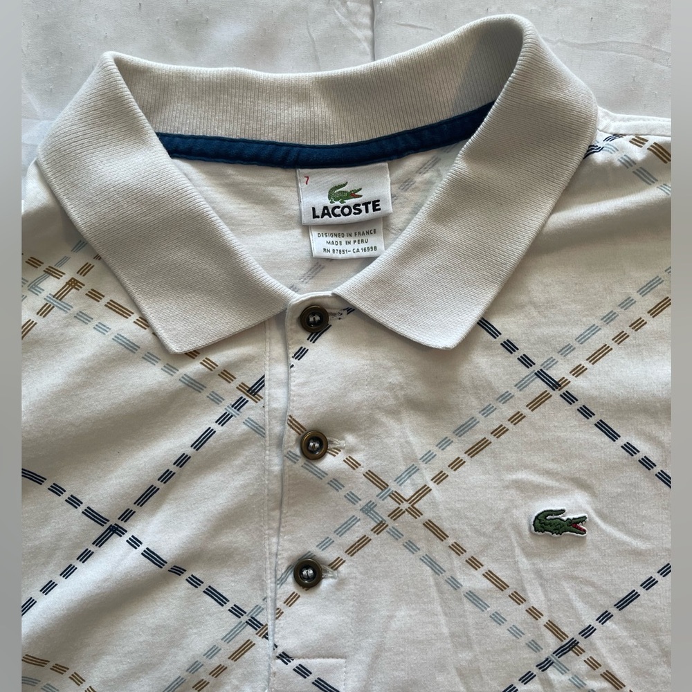 Lacoste polo. Size 7. In excellent condition, no marks or tears. Wrinkled photo!